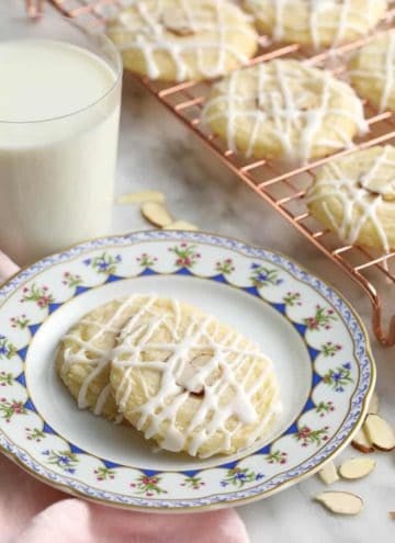 Almond cookies topped with two almond slivers and an almond glaze.