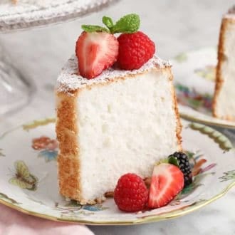 A slice of angel food cake on a porcelain plate.