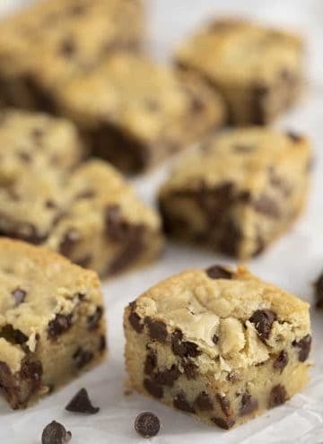 Chocolate chip cookie bars on a piece of parchment paper.