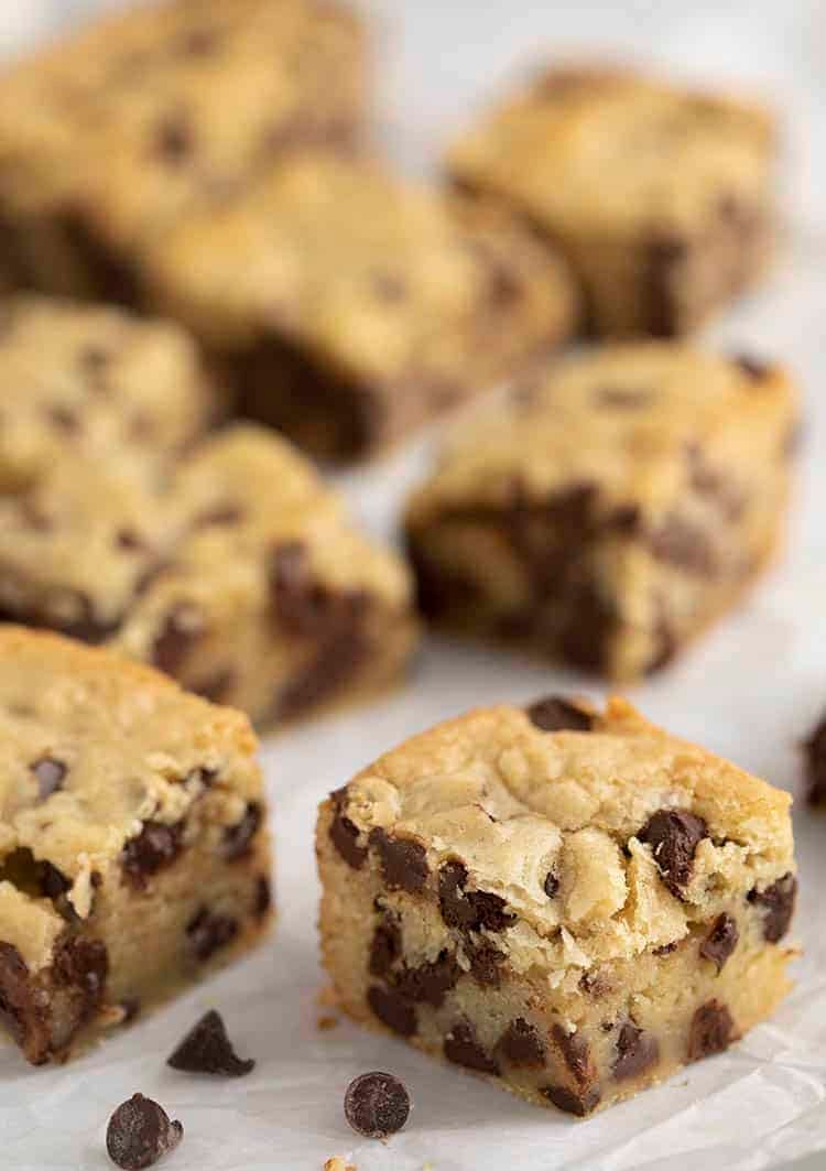 Chocolate chip cookie bars on a piece of parchment paper.