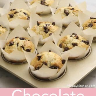 multiple chocolate chip muffins in a tin.