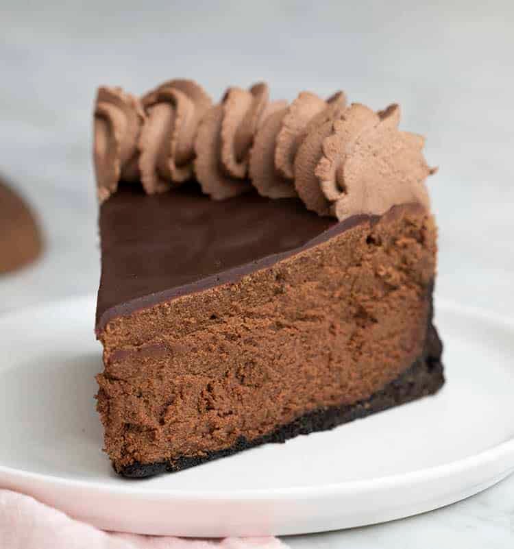 A piece of chocolate cheesecake on a white plate.