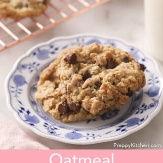 Two Oatmeal Chocolate Chip CookiesOatmeal Chocolate Chip Cookies on a porcelain plate next to a glass of milk.