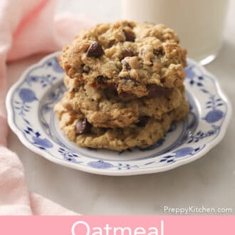 Three Oatmeal Chocolate Chip Cookies on a blue and white plate.
