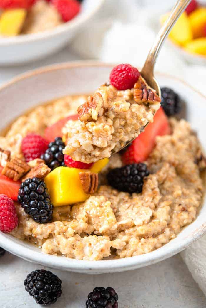 A close up of a spoonful of cooked steel cut oats