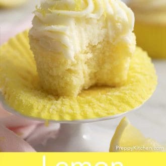 Pinterest graphic of lemon cupcake with lemon frosting with a bite taken out on a mini cake stand.