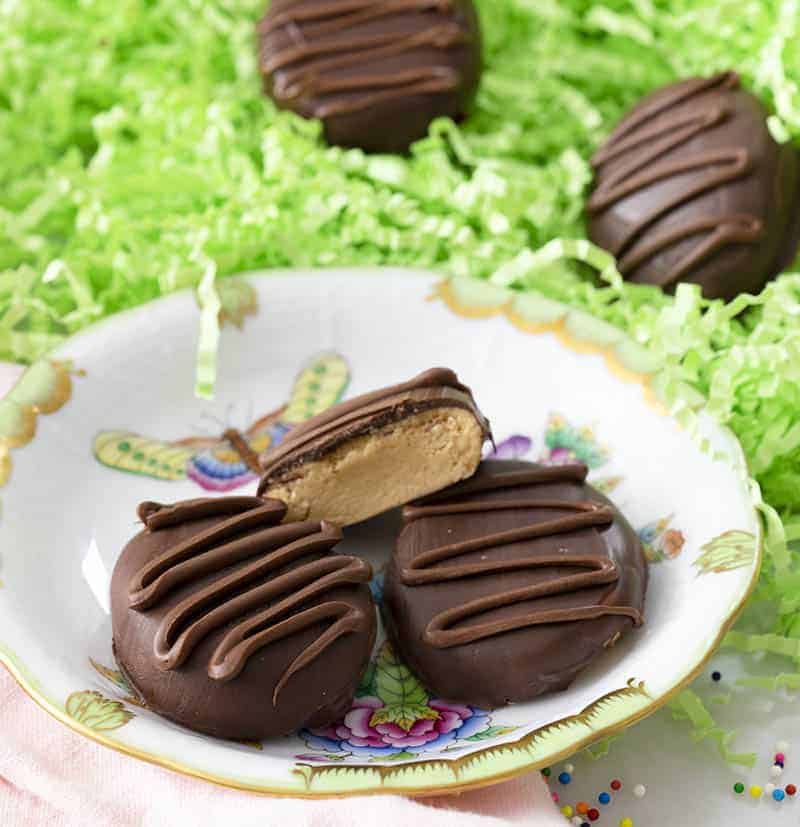 Chocolate covered Peanut butter eggs with a chocolate drizzle on top.