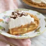 A slice of banoffee pie on a china plate