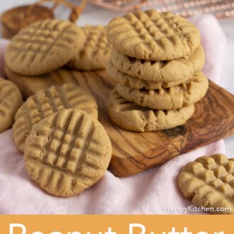 A group of peanut butter cookies on a wooden cutting board.