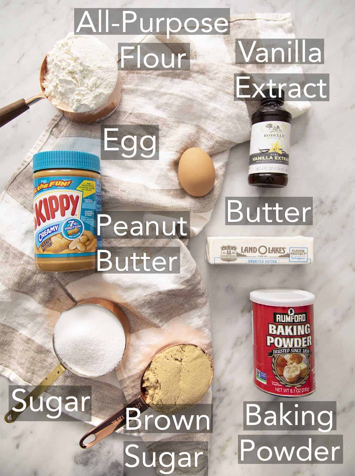 Ingredients for making peanut butter cookies on a counter.