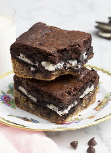Two slutty brownies stacked on top of each other on a plate.