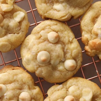 Pinterest graphic showing white chocolate chip macadamia nut cookies on a wire cooling rack.