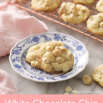 White chocolate chip macadamia nut Pinterest graphic showing macadamia nut cookies on a plate next to a pink napkin.