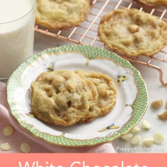Pinterest graphic showing white chocolate macadamia cookies on a plate with more on a cooling rack behind it.