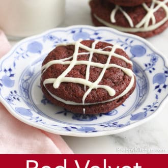 Pinterest graphic of a red velvet cookie on a plate with a stack of two in the background.