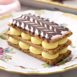 A delicious Mille Feuille topped with a chocolate chevron pattern.