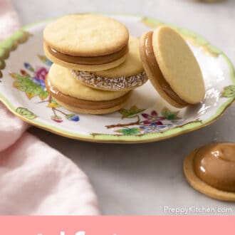 Pinterest graphic of a group of alfajores on a Herend plate.