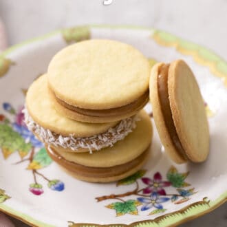Pinterest graphic of four alfajores on a porcelain plate.