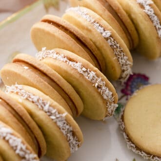 Pinterest graphic of alfajores cookies on a serving tray.