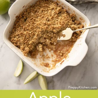 Pinterest graphic of a baking dish with apple crisp with a portion scooped out.