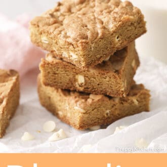Pinterest graphic of three white chocolate blondies staked on a marble counter.
