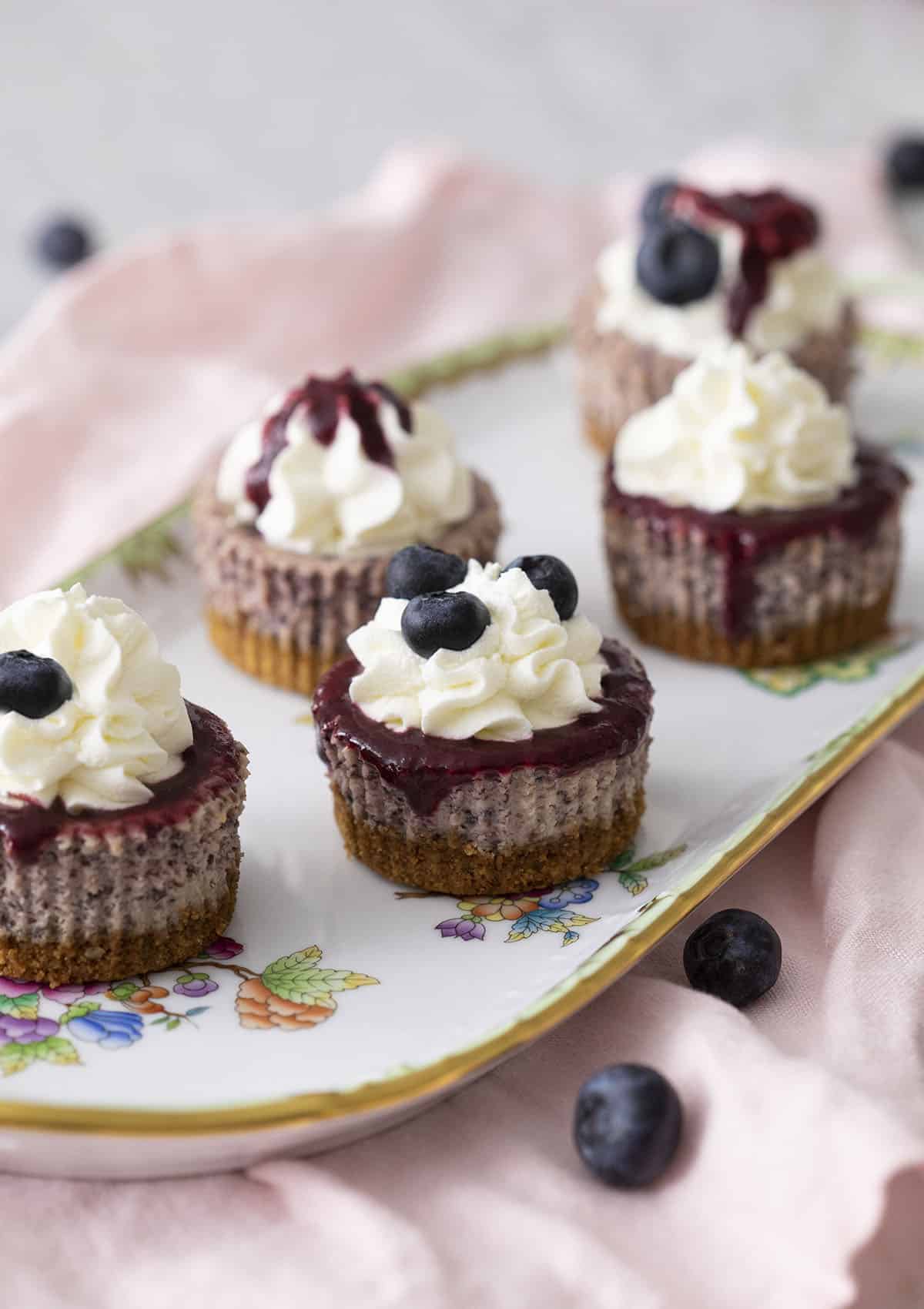A platter of blueberry mini cheesecake.