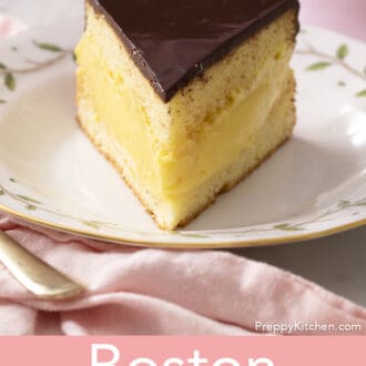 A piece of Boston cream pie on a porcelain plate.