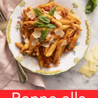 Penne alla vodka next to a pink napkin.