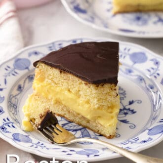 A Boston cream pie with a bite taken out.