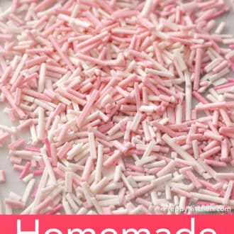 Many pink and white homemade sprinkles on a counter.
