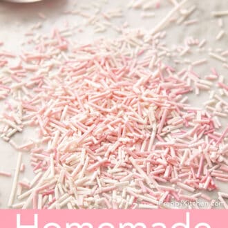 Light pink and white homemade sprinkles on a counter.