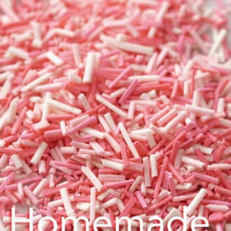 Various shades of pink homemade sprinkles on a marble counter.