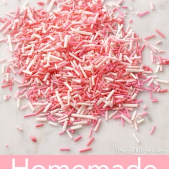 Pink homemade sprinkles on a marble counter.