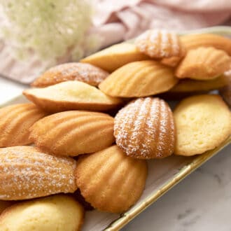 Pinterest graphic of madeleines on a tray next to a pink napkin.