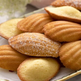 Madeleines on a porcelain serving tray.