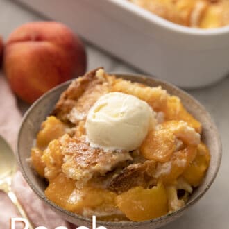 Pinterest graphic of a grey bowl brimming with peach cobbler.