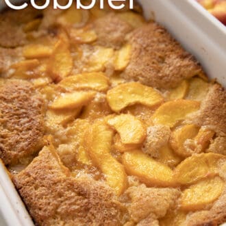 Pinterest graphic of peach cobbler in a white baking dish.