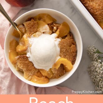 Pinterest graphic of a bowl of peach cobbler with a spoon inside.