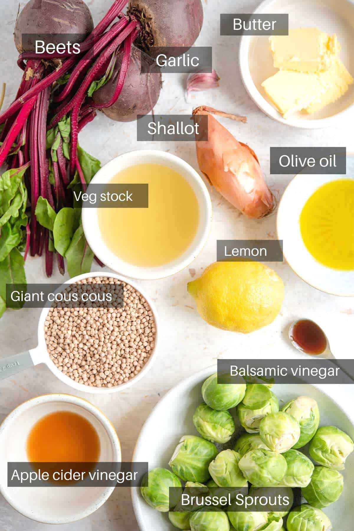 An overhead shot of all the ingredients you need to make giant cous cous, beets and Brussel sprouts