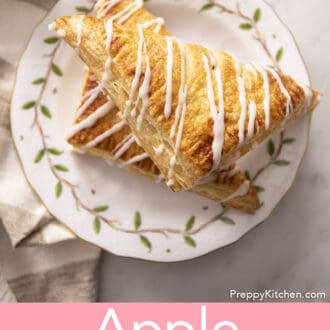 Pinterest graphic of two apple turnovers on a white plate.
