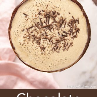 Pinterest graphic of a chocolate martini garnished with shaved chocolate next to a pink napkin.
