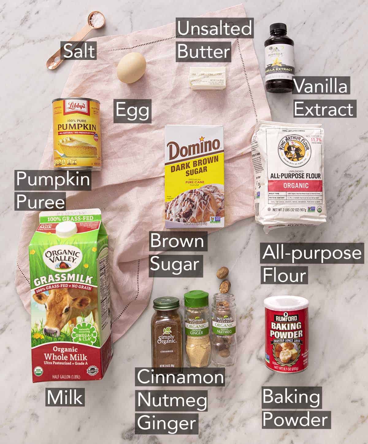 Ingredients to make Pumpkin Pancakes on a marble counter.