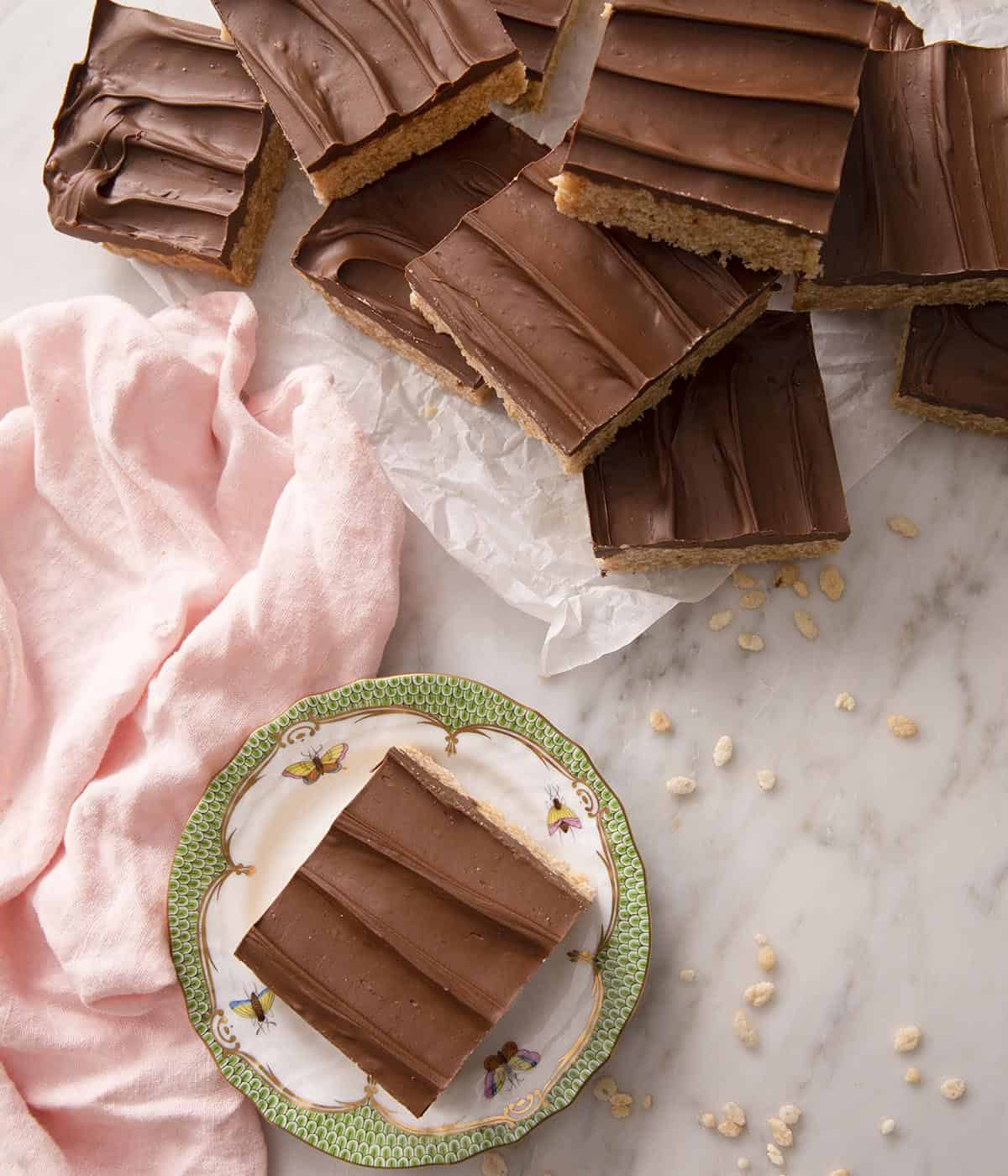 A group of scotcherooos with one on a small plate.
