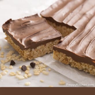 Pinterest graphic of a block of scotcheroos with one piece cut out next to some chocolate chips.