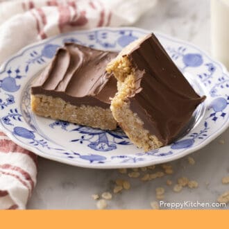 Pinterest graphic of two scotcheroos on a blue and white plate.