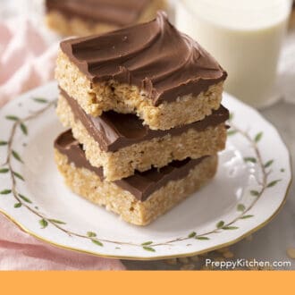 Pinterest graphic of three scotcheroos on a plate.