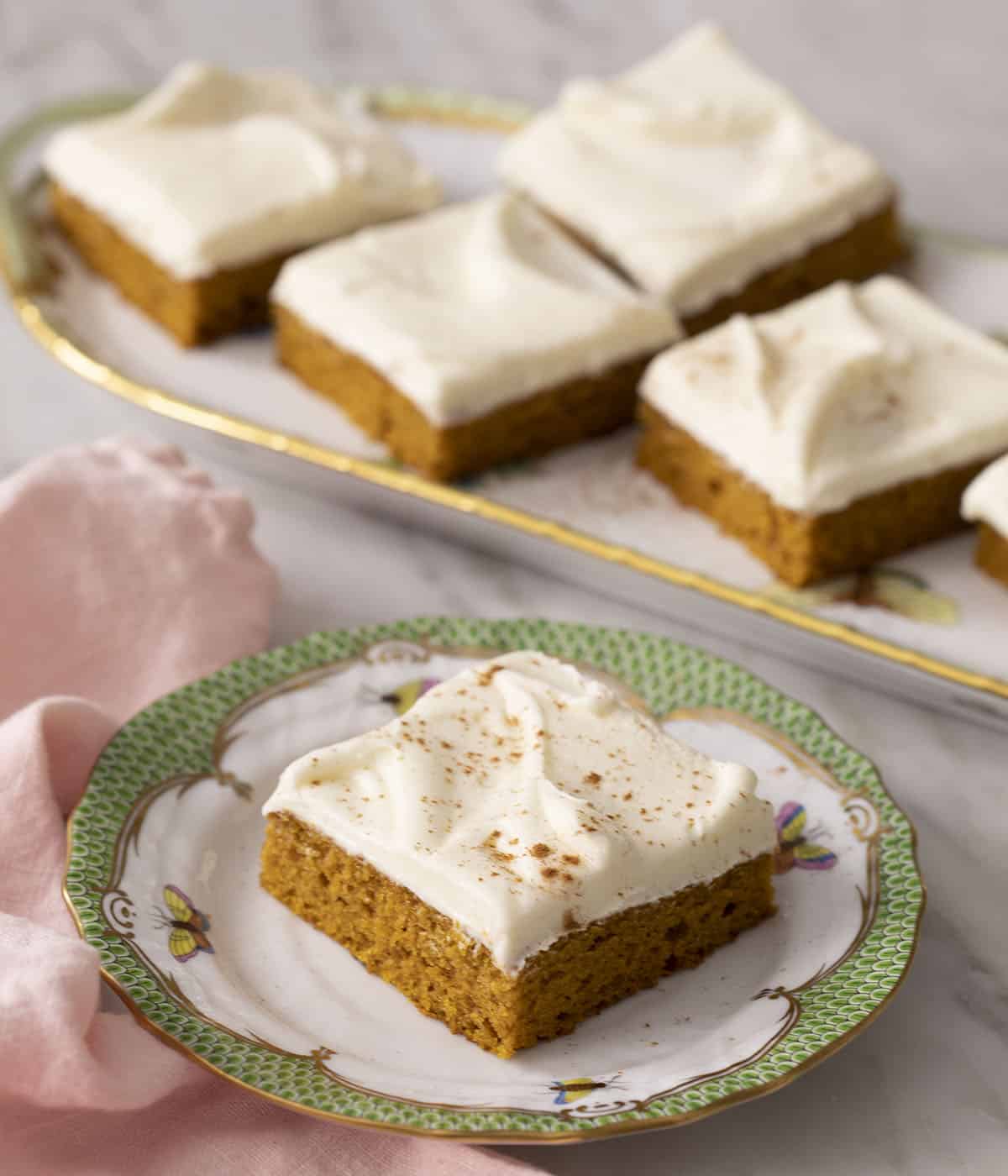 Pumpkin bars on a porcelain serving tray.