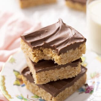 Pinterest graphic of three scotcheroos stacked on a plate, the top one has a bite taken out.