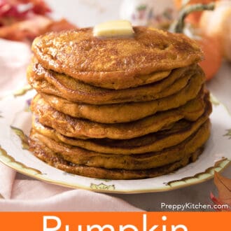 Pumpkin pancakes wiht butter and syrup on a plate.