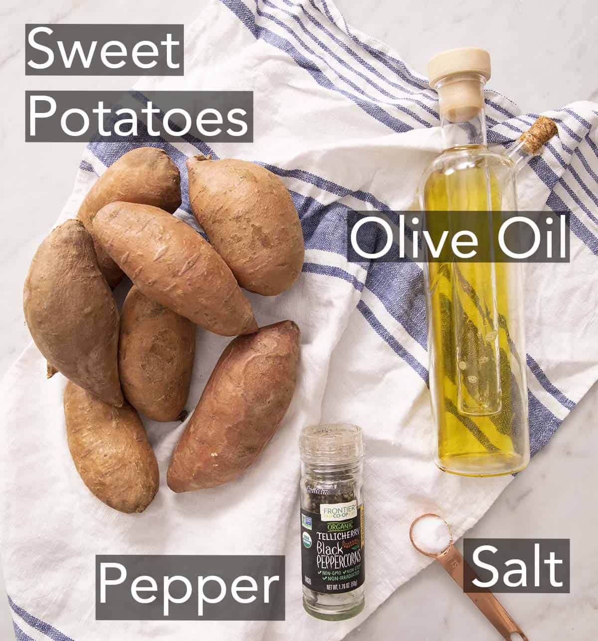 Ingredients to make roasted sweet potatoes laying on a striped napkin